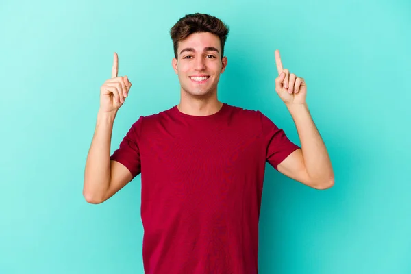 Homem Caucasiano Jovem Isolado Fundo Azul Indica Com Ambos Dedos — Fotografia de Stock