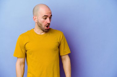 Mor arka planda izole genç, beyaz kel adam gördüğü bir şey yüzünden şoka uğruyor..