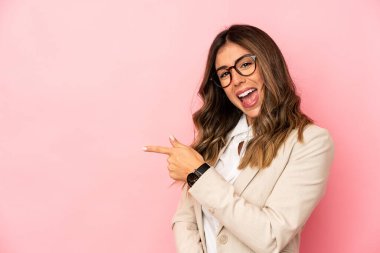 Kafkasyalı genç bir kadın kendini izole edip gülümsüyor ve boş alanda bir şeyler gösteriyor..