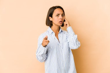 Genç İspanyol kadın, tapınağı parmağıyla göstererek, düşünerek, bir göreve odaklandı..