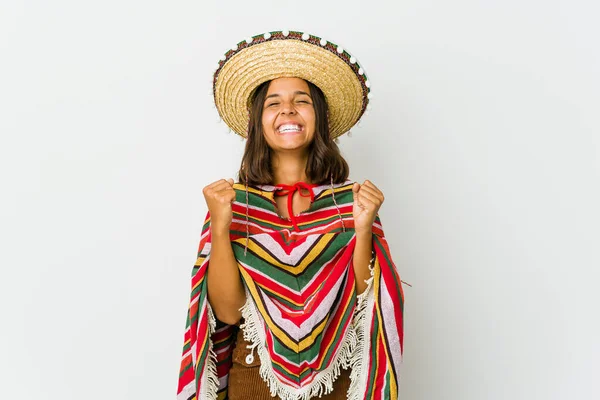 Young mexican woman isolated on white background celebrating a victory, passion and enthusiasm, happy expression.