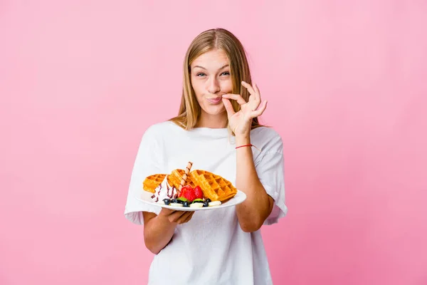 Young Russian Woman Eating Waffle Isolated Fingers Lips Keeping Secret — Stock Photo, Image