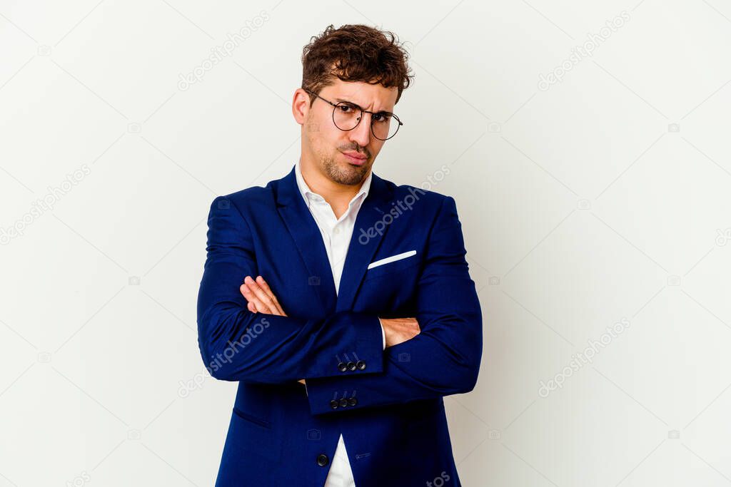 Young business caucasian man isolated on white background frowning face in displeasure, keeps arms folded.