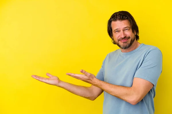 Middle Age Caucasian Man Isolated Yellow Background Holding Copy Space — Stock Photo, Image