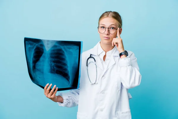 Young Russian Doctor Woman Holding Bone Scan Blue Pointing Temple — Stock Photo, Image