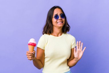 Dondurma yiyen genç bir ırk kadını iğrenme hareketi gösteren birini reddediyor..