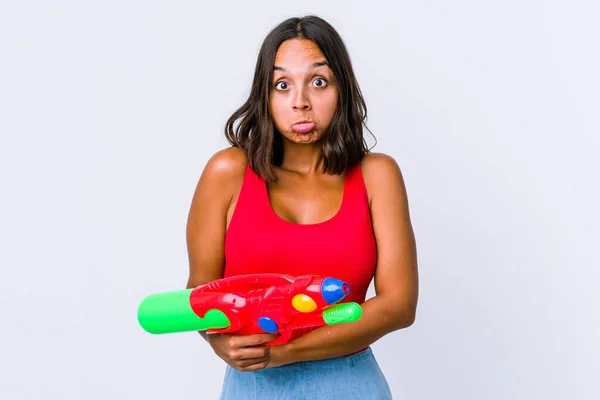 Young Mixed Race Woman Holding Water Gun Isolated Shrugs Shoulders — 스톡 사진