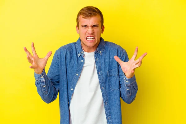 Young Caucasian Man Isolated Yellow Background Screaming Rage — Stock Photo, Image