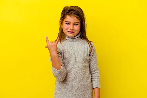 小さなCaucasian女の子絶縁上の黄色の背景ショー岩ジェスチャーとともに指 — ストック写真