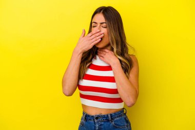 Sarı arka planda izole edilmiş genç beyaz kadın virüs ya da enfeksiyon yüzünden boğazında ağrı hissediyor..