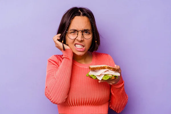 Young Mixed Race Woman Holding Sandwich Isolated Purple Background Covering — Stock Photo, Image