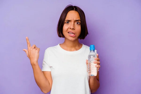 Young Mixed Race Holding Water Bottle Isolated Purple Background Showing — Stock Photo, Image