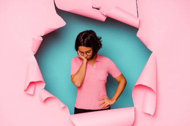 Kırık arka planda kalan melez bir kadın parmağını göstererek şaşırdı ve gülümsedi..