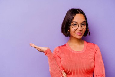 Mor arka planda izole edilmiş genç bir ırk kadını bir avuç içinde fotokopi alanı ve belinde başka bir el tutarken görülüyor..