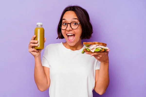 Young Mixed Race Woman Holding Healthy Smoothie Sandwich Isolated Purple — Stock Photo, Image