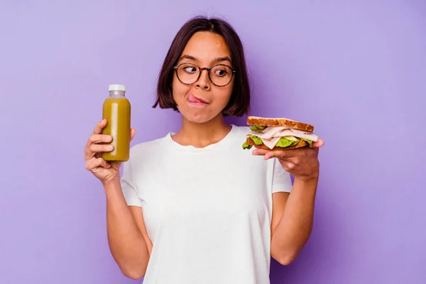 Young Mixed Race Woman Holding Healthy Smoothie Sandwich Isolated Purple — Stock Photo, Image