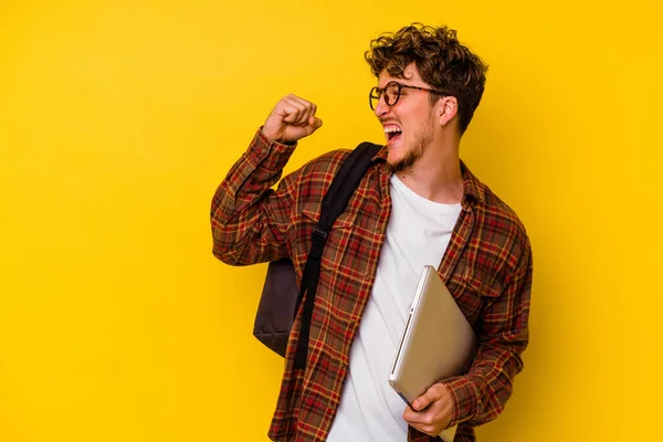 Mladý Student Běloch Drží Notebook Izolovaný Žlutém Pozadí Zvedající Pěst — Stock fotografie