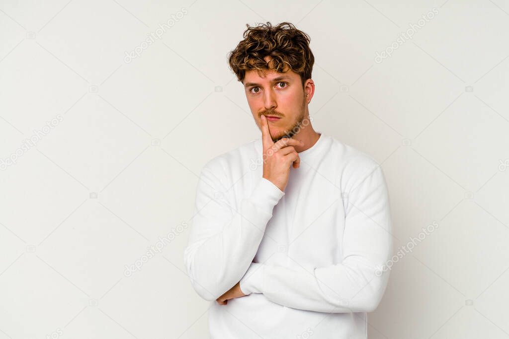 Young caucasian man isolated on white background unhappy looking in camera with sarcastic expression.