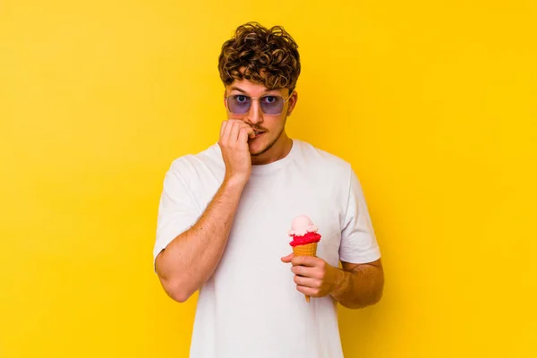 Young Caucasian Man Eating Ice Cream Isolated Yellow Background Biting — Stock Photo, Image