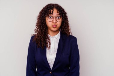 Beyaz arka planda izole edilmiş genç iş kadını yanakları şişer, yorgun bir ifadesi vardır. Yüz ifadesi kavramı.