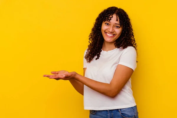 Young Mixed Race Woman Isolated Yellow Background Holding Copy Space — Stock Photo, Image
