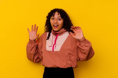 Pembe arka planda izole edilmiş genç melez bir kadın yaklaşan bir tehlike nedeniyle şok oluyor.