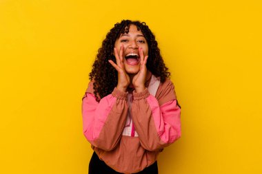 Pembe arka planda soyutlanmış genç melez bir kadın heyecanlı bir şekilde bağırıyor..