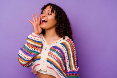 Mor arka planda izole edilmiş genç bir ırk kadını bağırıyor ve avuç içini açık tutuyor..