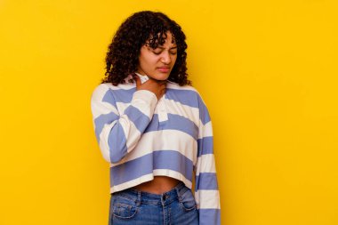 Sarı arka planda izole edilmiş genç melez kadın virüs ya da enfeksiyon yüzünden boğazında ağrı hissediyor..