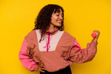 Sarı arka planda soyutlanmış genç, melez bir kadın.