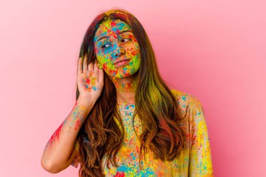 Kutsal festivali kutlayan genç Hintli kadın beyaz arka planda izole edilmiş bir şekilde bir dedikoduyu dinlemeye çalışıyor..