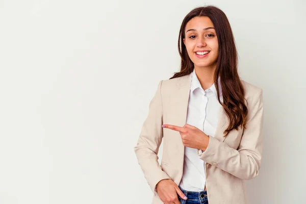 Young Indian business woman isolated on white background smiling and pointing aside, showing something at blank space.