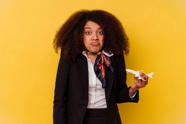 Young African American Air Hostess Holding Little Plane Isolated Yellow — Stock Photo, Image