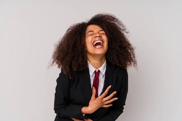 白い背景に隔離されたスーツを着ている若いアフリカ系アメリカ人のビジネス女性は喜んで笑い 胃の上に手を保つ楽しみを持っています — ストック写真