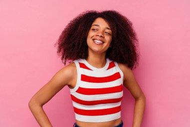 Genç Afrikalı Amerikalı kadın pembe arka planda izole edilmiş hedeflerine ve amaçlarına ulaşma hayali kuruyor.