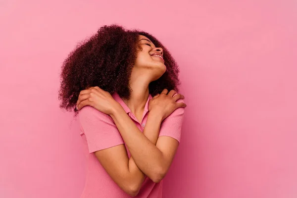 Young African American Woman Isolated Pink Background Hugs Smiling Carefree — Stock Photo, Image