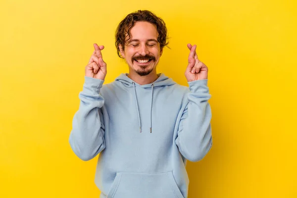 Young Caucasian Man Isolated Yellow Background Crossing Fingers Having Luck — Stock Photo, Image