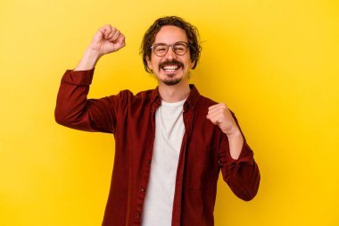 Genç beyaz adam sarı arka planda izole edilmiş dans ediyor ve eğleniyor..