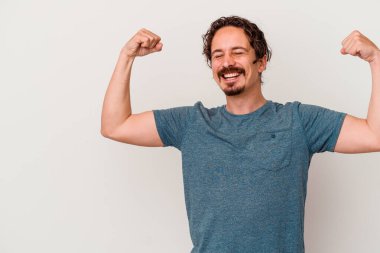 Beyaz arka planda izole edilmiş genç beyaz bir adam zaferden sonra yumruğunu kaldırıyor, kazanan konsept.