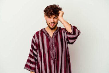 Beyaz arka planda izole edilmiş genç Faslı bir adam bir şeyi unutuyor. Alnına avuç içi ve gözlerini kapayarak vuruyor..