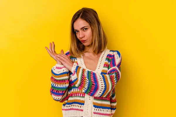 Young caucasian skinny woman isolated on yellow background feeling energetic and comfortable, rubbing hands confident.