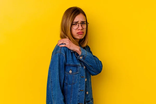 Young caucasian skinny woman isolated on yellow background having a shoulder pain.