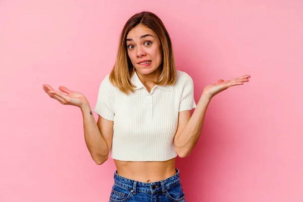 Mujer Joven Caucásica Aislada Sobre Fondo Rosa Confundida Dudosa Hombros —  Fotos de Stock