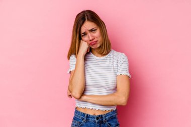 Pembe arka planda izole edilmiş genç beyaz kadın tekrarlanan bir görevden bıktı..