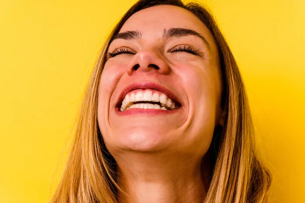 Young caucasian woman wearing invisible orthodontics isolated on yellow background