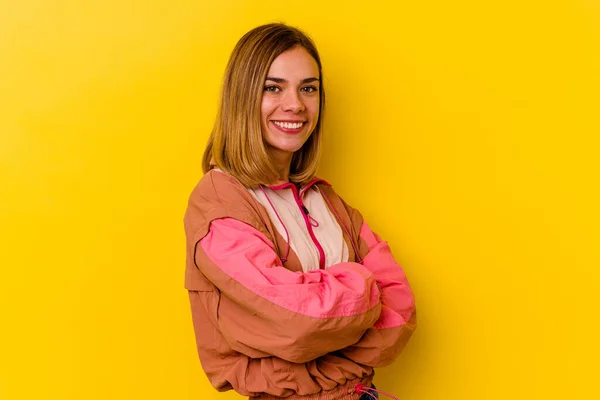 Young caucasian skinny woman isolated on yellow background laughing and having fun.