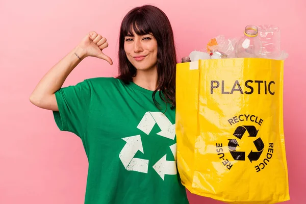 Jovem Caucasiana Segurando Saco Plástico Reciclado Isolado Fundo Rosa Sente — Fotografia de Stock