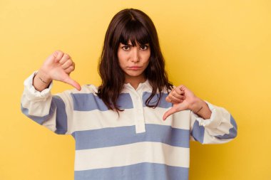 Sarı arka planda izole edilmiş, hoşlanmadığı bir hareket gösteren beyaz bir kadın var. Anlaşmazlık konsepti.