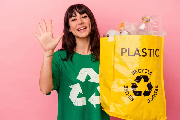 Jovem Caucasiana Segurando Saco Plástico Reciclado Isolado Fundo Rosa Sorrindo — Fotografia de Stock