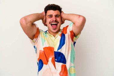 Beyaz arka planda izole edilmiş genç beyaz bir adam öfkeyle bağırıyor..